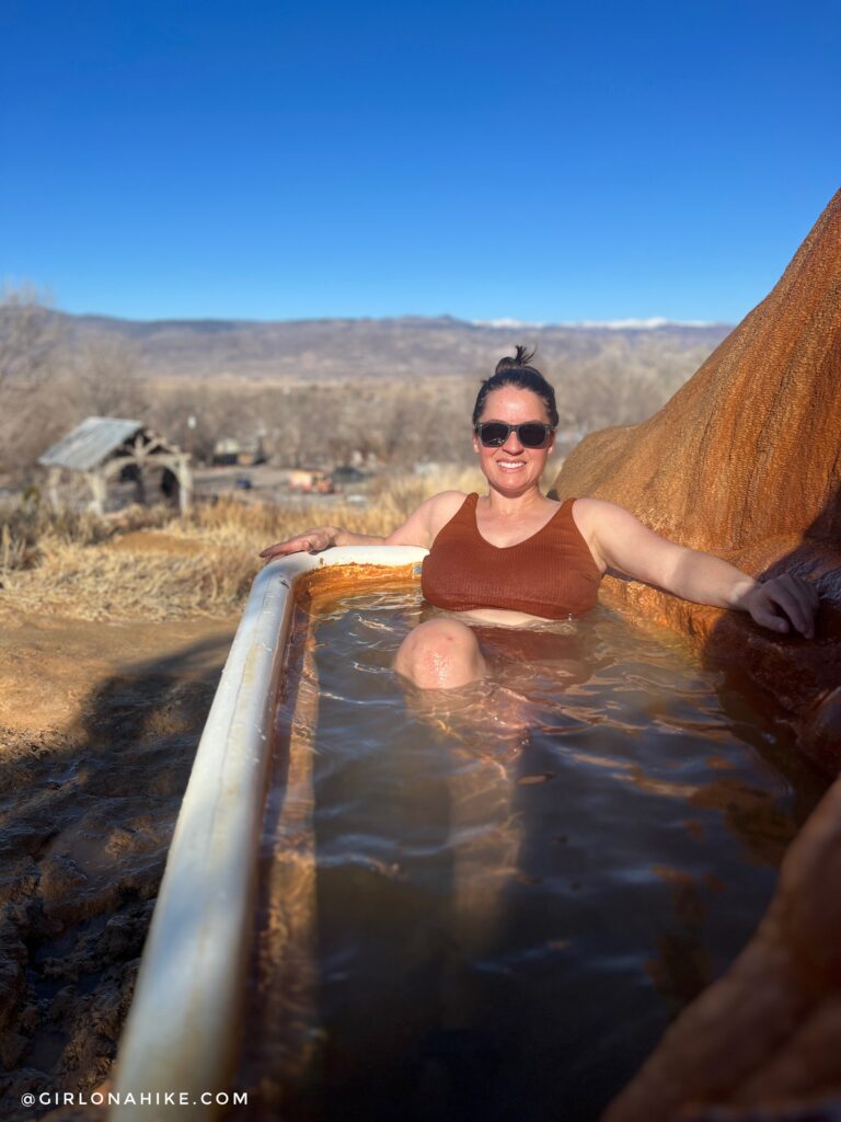 woman soaking in a private hot tub at Monroe Hot Springs, Utah