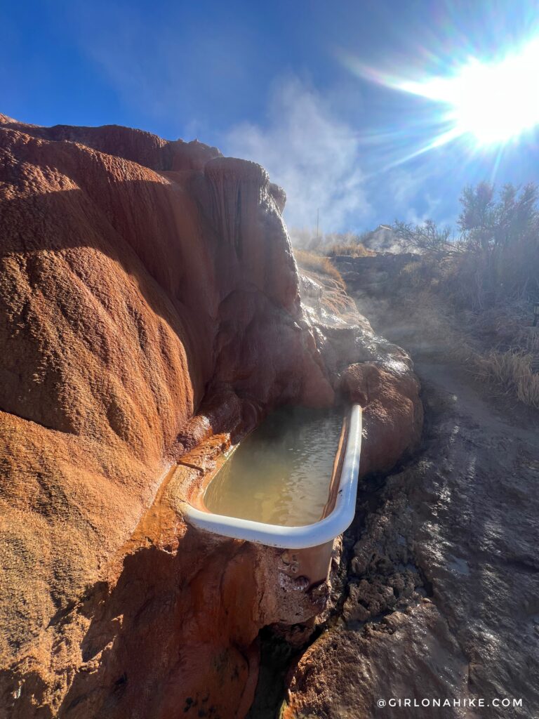 rock-lined hot tub at Monroe Hot Springs with sunlight and natural stone surroundings