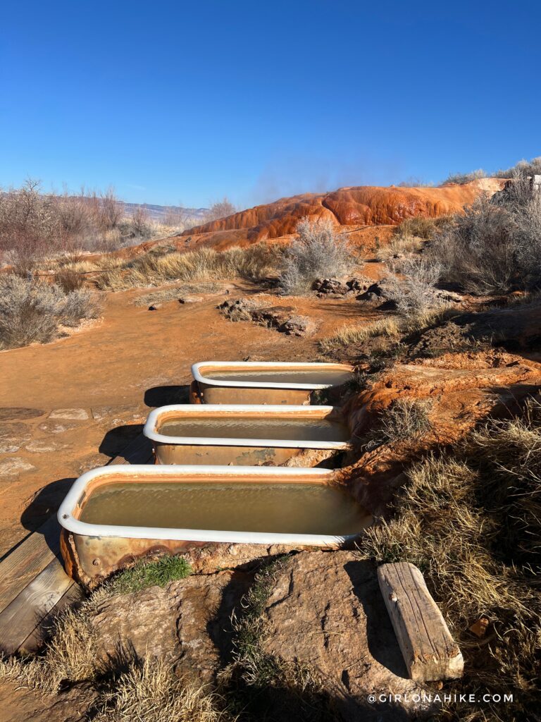 row of private hot tubs at Monroe Hot Springs in Utah with mountain views