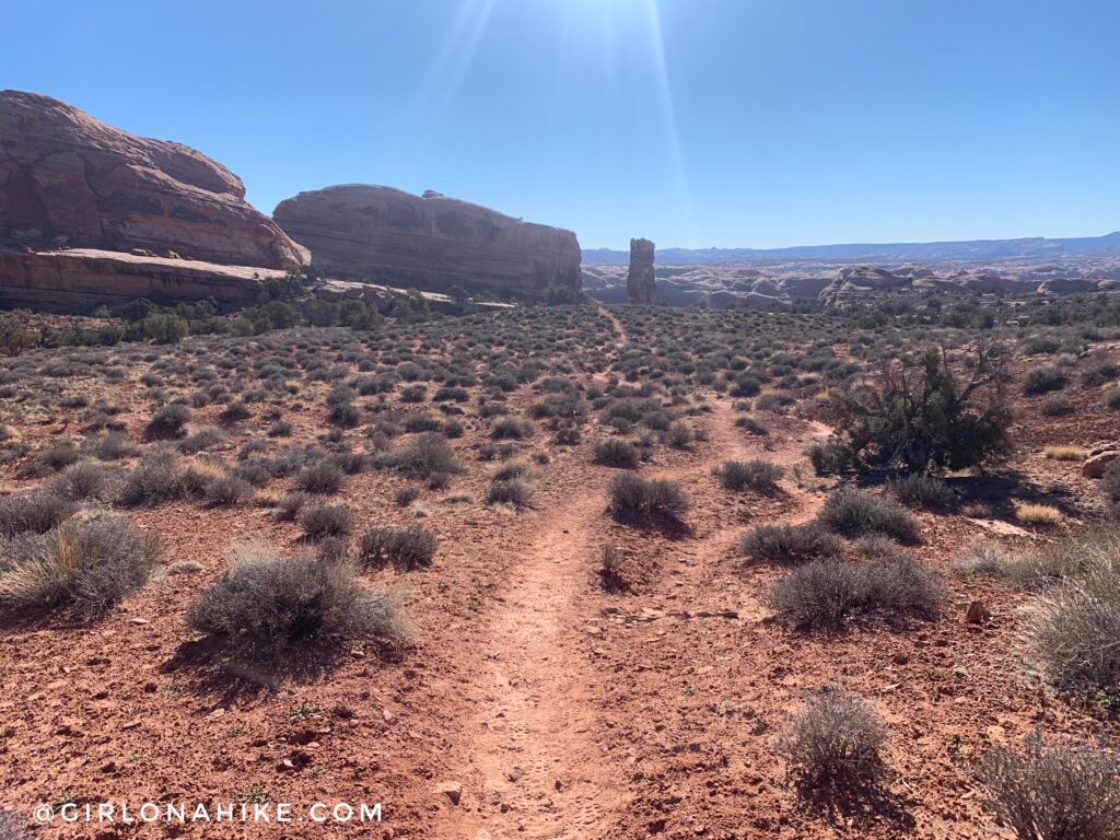 As soon as you pass the barbed wire fence, start keeping an eye out for cairns to guide you. The trail is a mix of slick rock, sandstone, and sand.